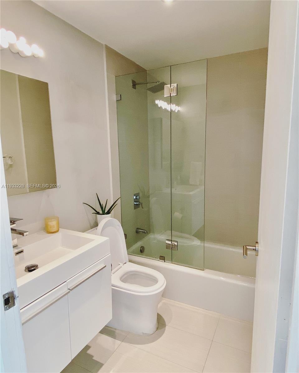 888 Brickell Key Drive, Unit 2209 Miami, FL 33131 - Photo 5 of 5 a bathroom with a sink toilet and shower