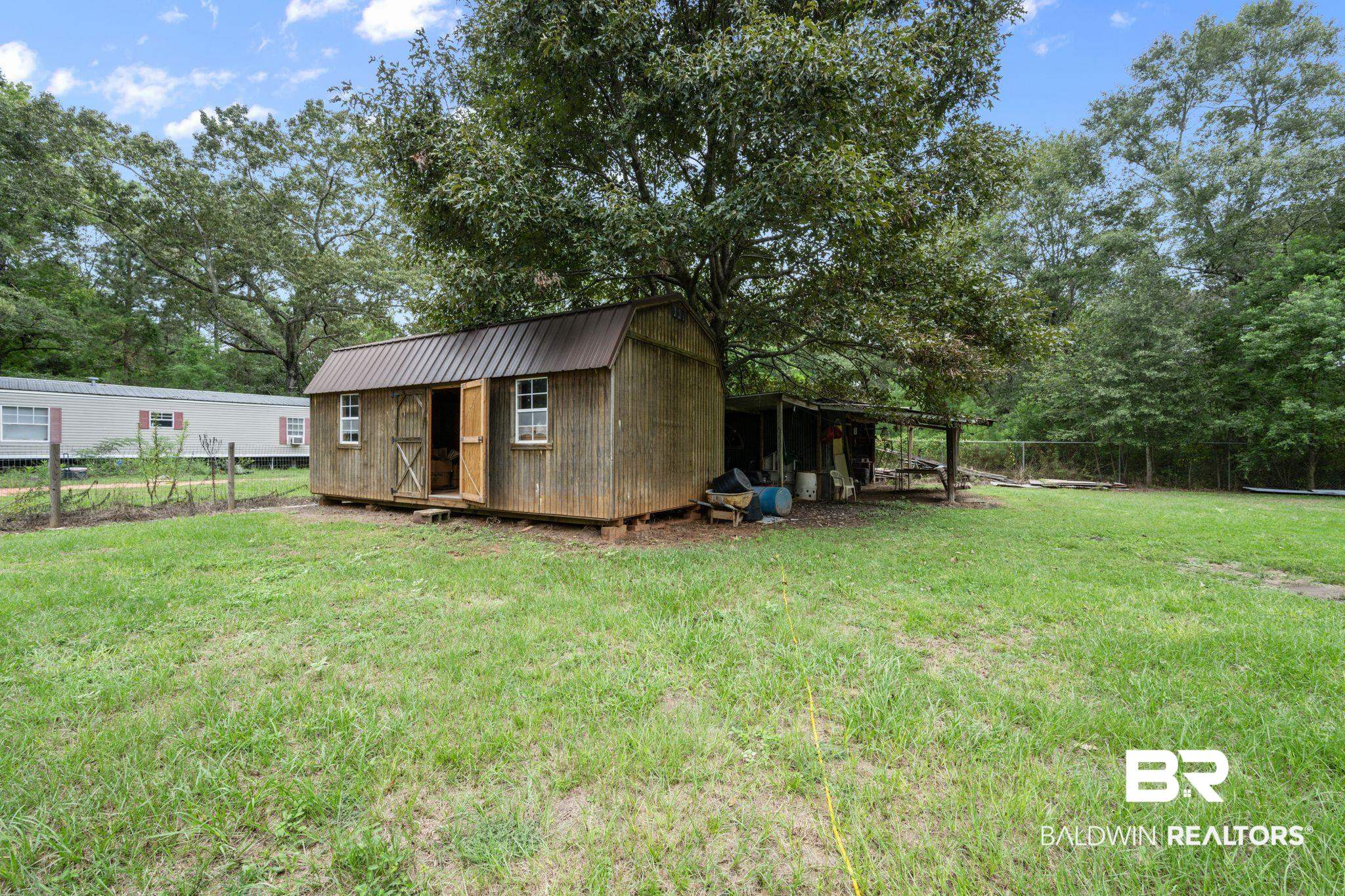 54855 Ramer Drive Bay Minette, AL 36507 - Photo 8 of 20 View of yard with a storage shed