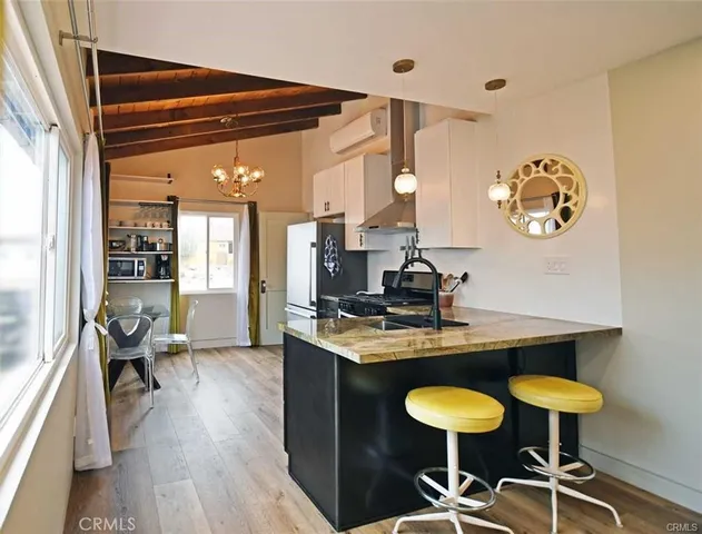 a view of a room with a table and chairs