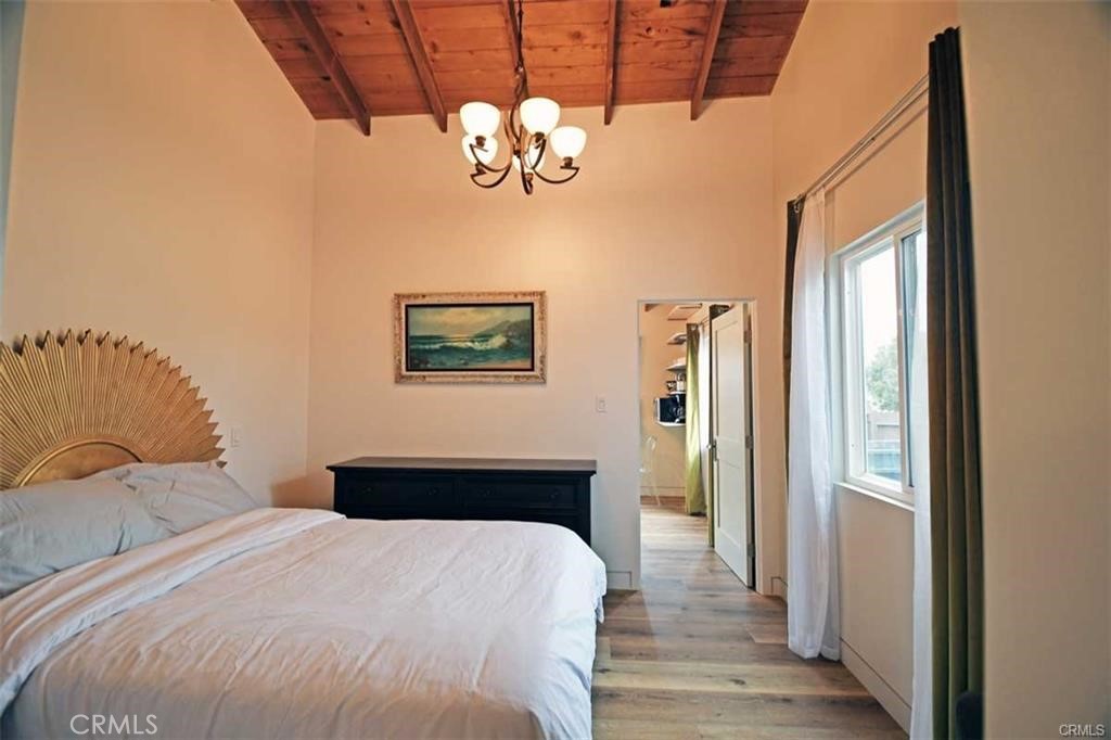 117 Kenneth Street Camarillo, CA 93010 - Photo 7 of 10 a bedroom with a bed and a chandelier