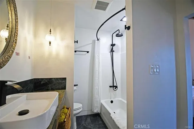 a bathroom with a tub a sink and a shower