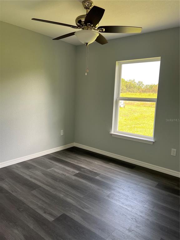 21260 Southwest Marine Boulevard Dunnellon, FL 34431 - Photo 5 of 13 a view of an empty room with wooden floor and a window