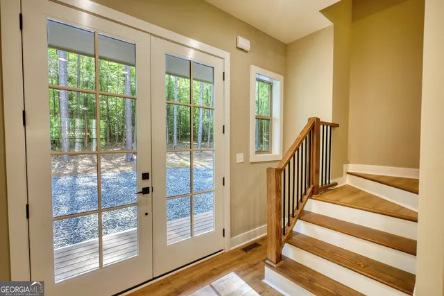 a large kitchen with granite countertop a large counter top stainless steel appliances and wooden floor