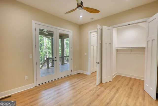a view of a hallway with wooden floor and windows