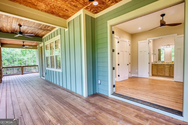 a view of a porch with wooden floor and outdoor space