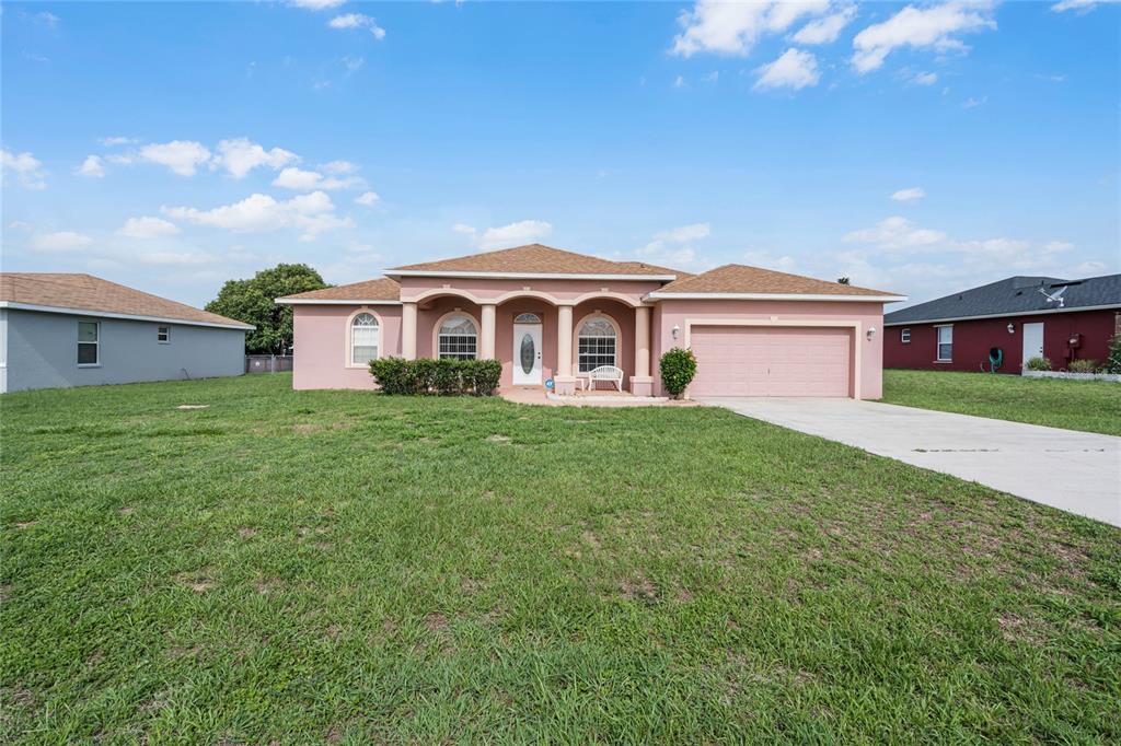 a front view of a house with a garden