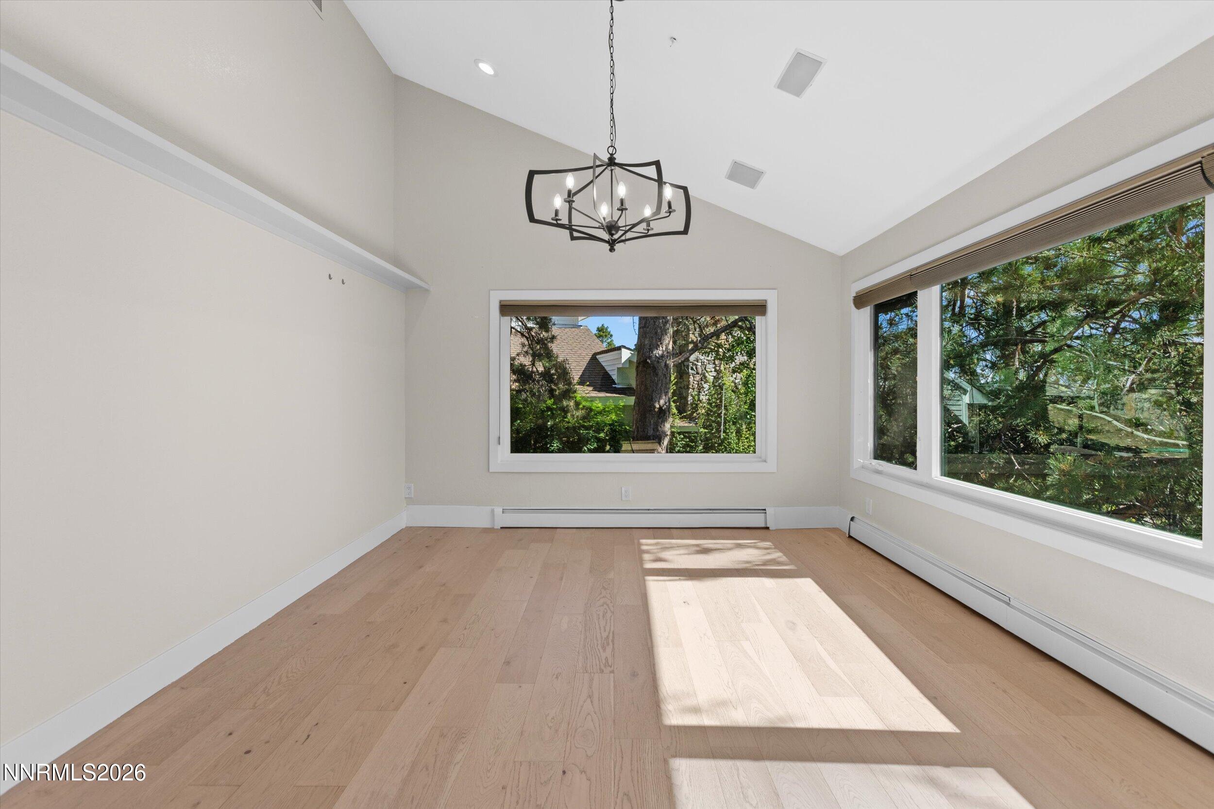 2725 West Lake Ridge Shores Reno, NV 89519 - Photo 12 of 49 a view of an empty room with wooden floor and a window