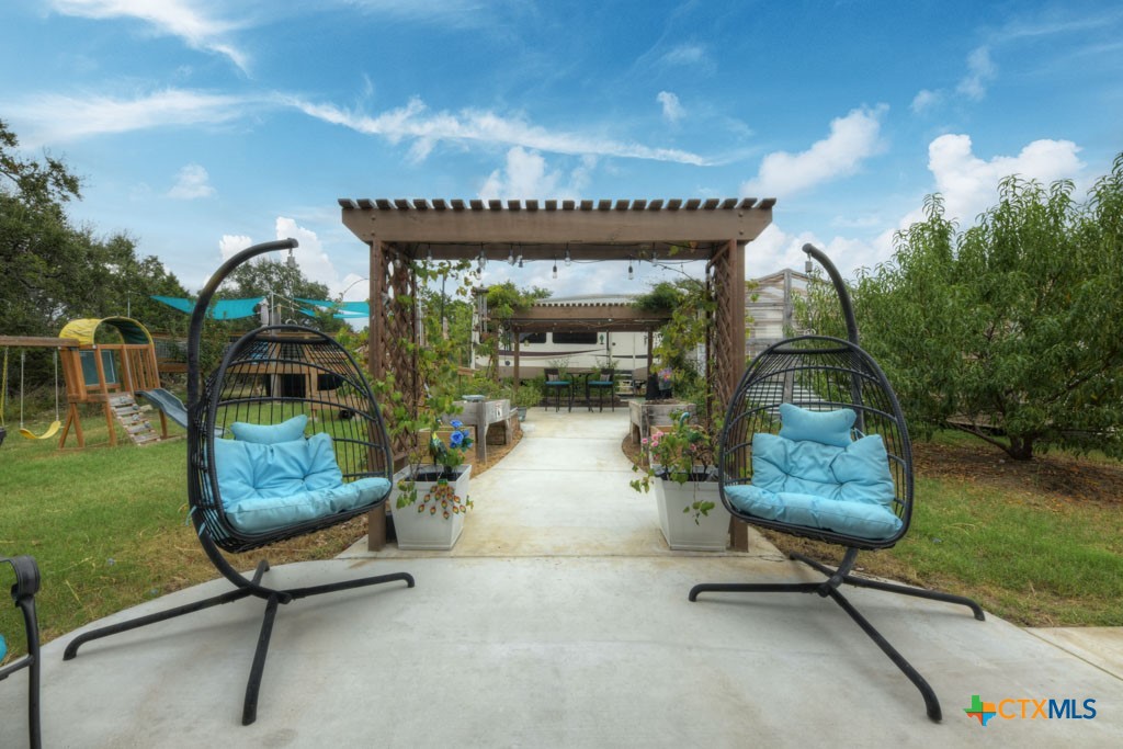 861 Rutherford Fischer, TX 78623 - Photo 15 of 38 Multiple outdoor seating areas leading to RV pad site, pool, metal storage shed and greenhouse.