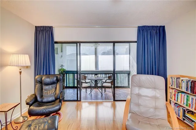 a dining room with furniture and floor to ceiling window