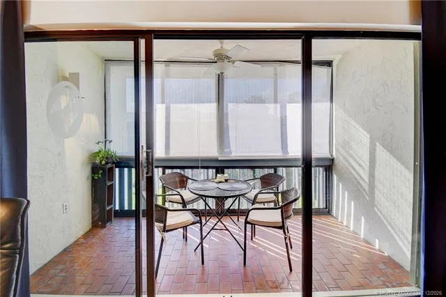 a view of a hallway with wooden floor and table