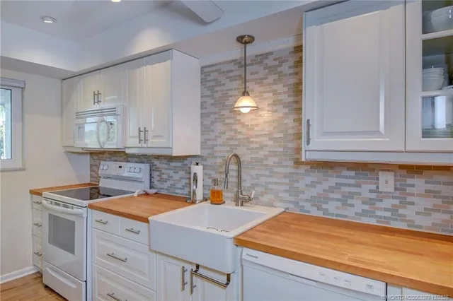 a kitchen with a sink cabinets and window