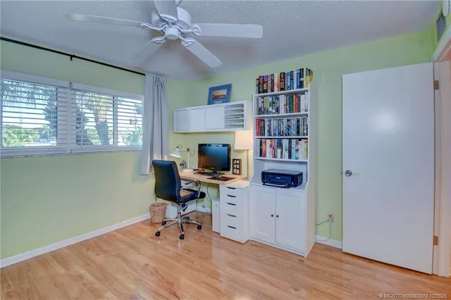 a view of a workspace with furniture and a bookshelf