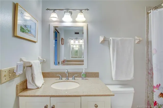a bathroom with a sink vanity and a mirror
