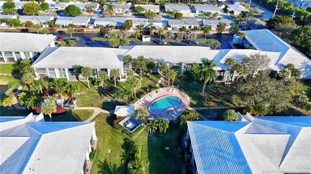 an aerial view of a houses with yard