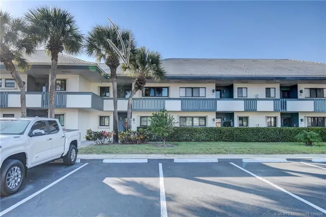 a view of a car parked in front of a brick house