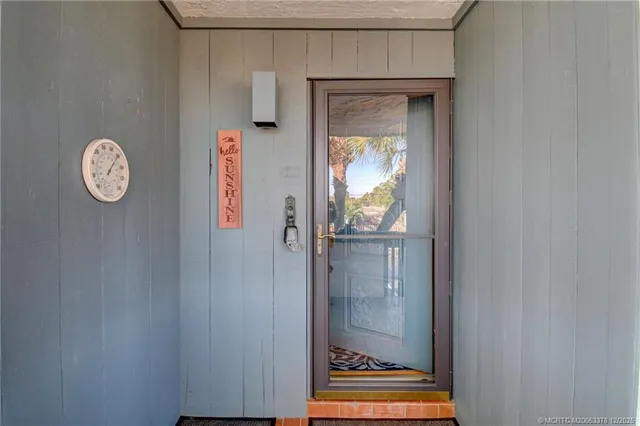 a view of a hallway with wooden door