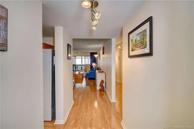 a view of a living room and dining room with wooden floor