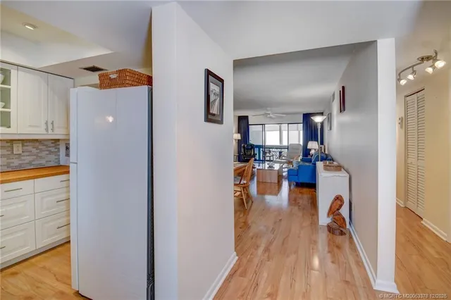 a view of living room with furniture and wooden floor
