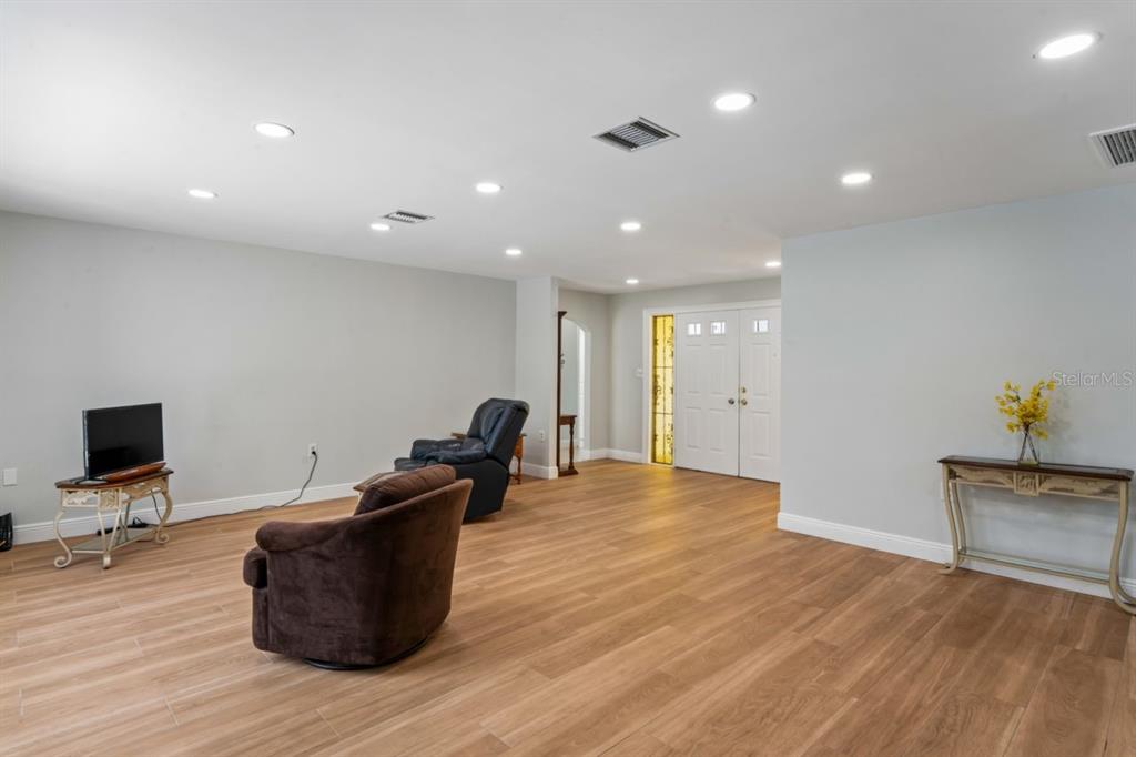 6955 Bottle Brush Drive Port Richey, FL 34668 - Photo 11 of 61 a living room with furniture and a flat screen tv