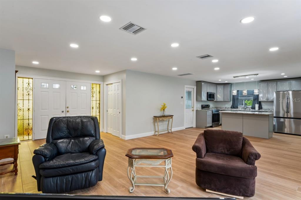 6955 Bottle Brush Drive Port Richey, FL 34668 - Photo 12 of 61 a living room with furniture and kitchen view