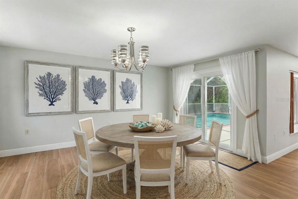 6955 Bottle Brush Drive Port Richey, FL 34668 - Photo 19 of 61 a view of a dining room with furniture window and wooden floor