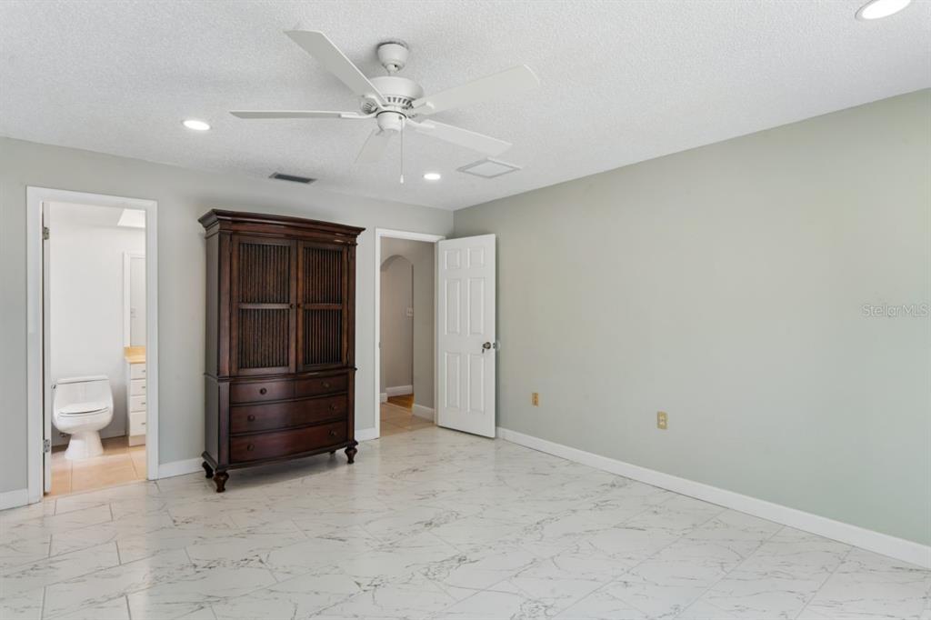6955 Bottle Brush Drive Port Richey, FL 34668 - Photo 24 of 61 an empty room with chandelier fan and closet
