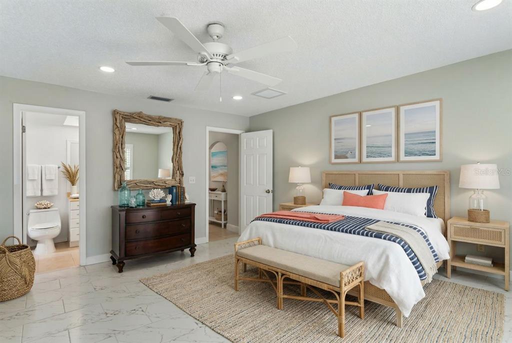 6955 Bottle Brush Drive Port Richey, FL 34668 - Photo 25 of 61 a bedroom with a bed and ceiling fan