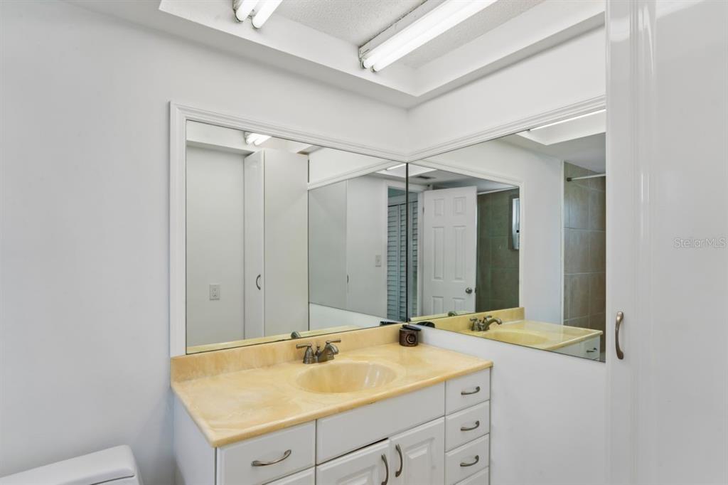 6955 Bottle Brush Drive Port Richey, FL 34668 - Photo 27 of 61 a bathroom with a sink and a mirror