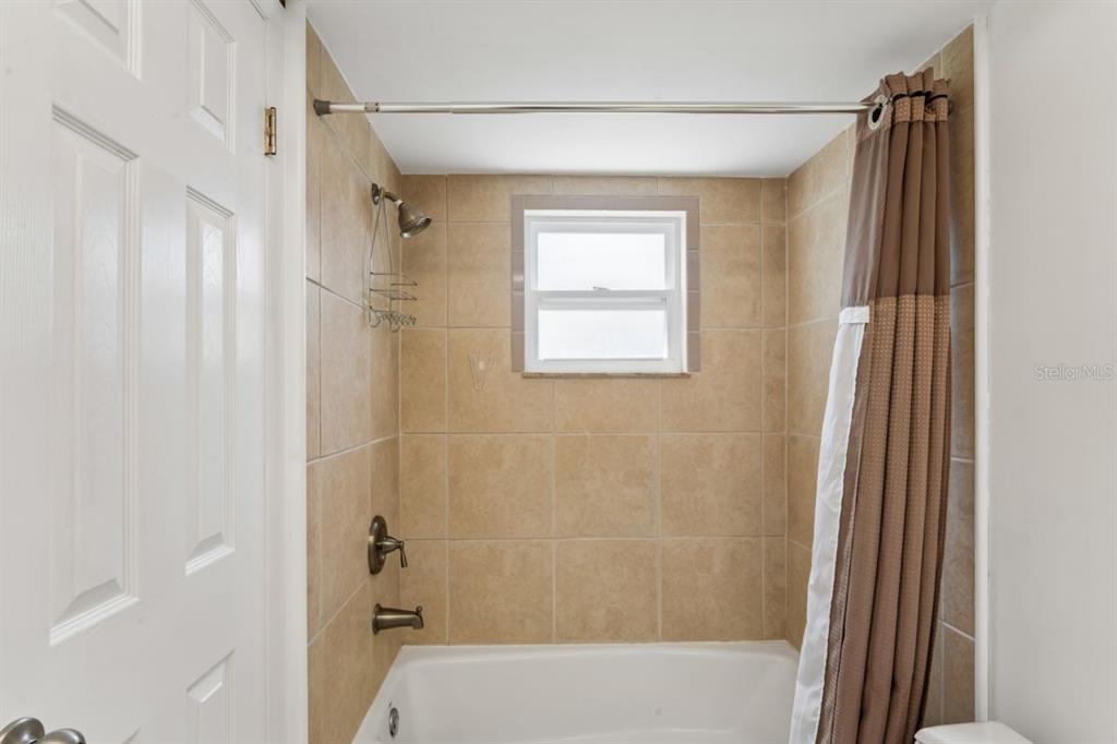 6955 Bottle Brush Drive Port Richey, FL 34668 - Photo 28 of 61 a bathroom with a bathtub and shower