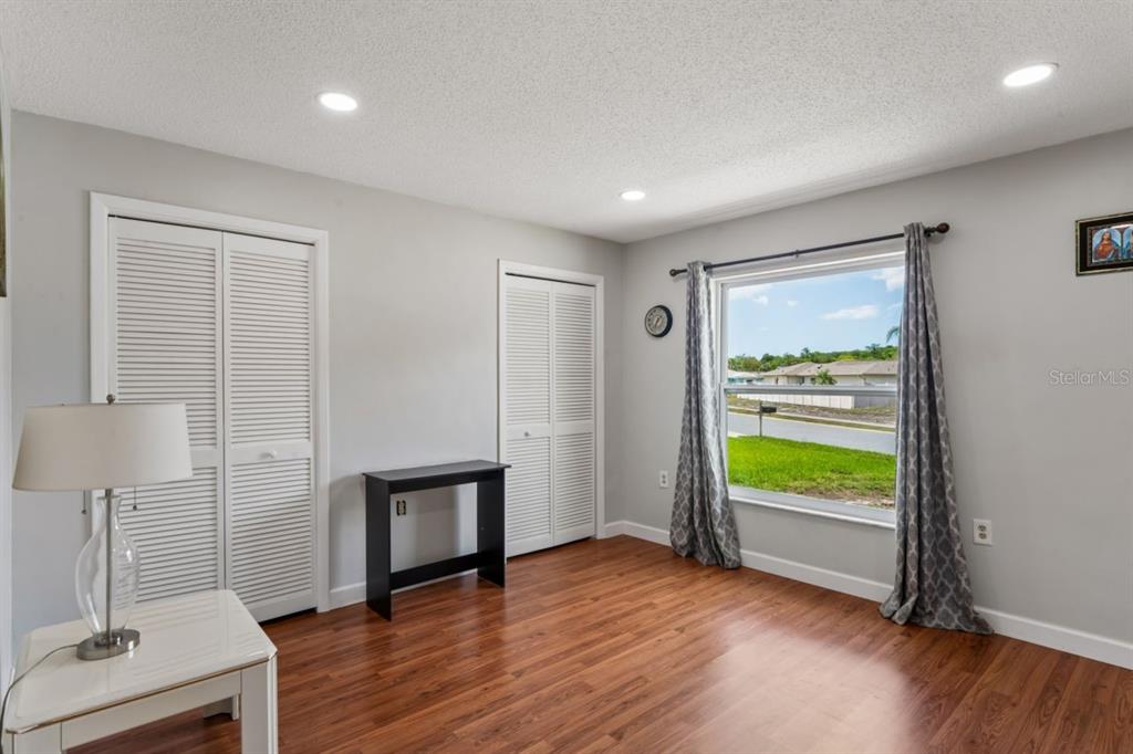 6955 Bottle Brush Drive Port Richey, FL 34668 - Photo 29 of 61 a view of an empty room with a window and wooden floor