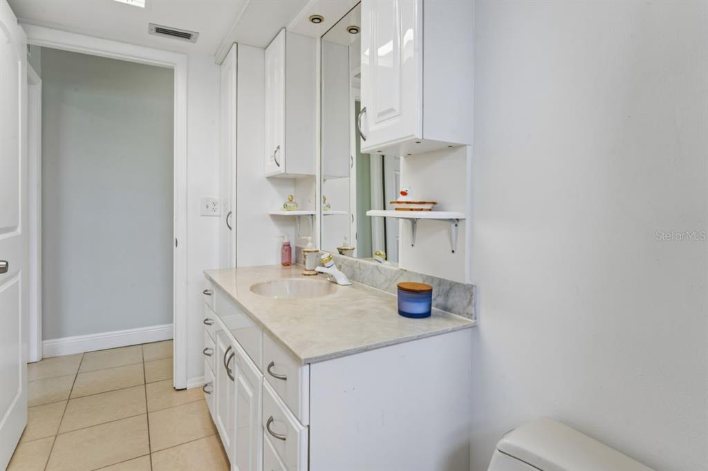 6955 Bottle Brush Drive Port Richey, FL 34668 - Photo 33 of 61 a kitchen with stainless steel appliances a sink stove and white cabinets