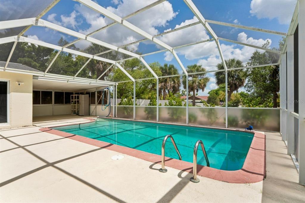 6955 Bottle Brush Drive Port Richey, FL 34668 - Photo 37 of 61 a view of a swimming pool with a patio
