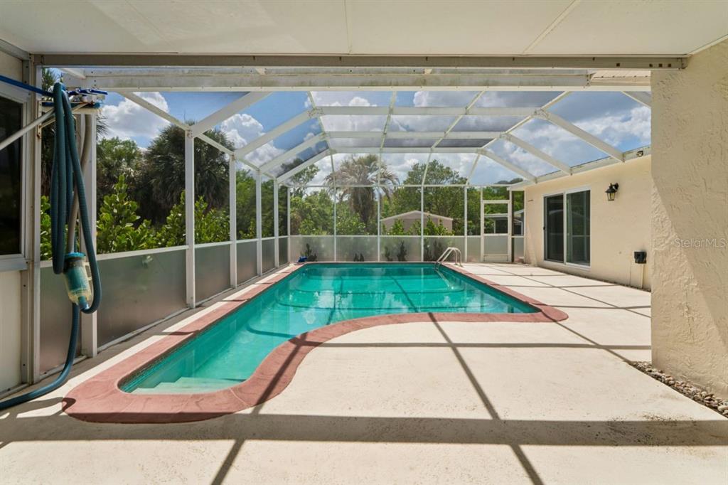 6955 Bottle Brush Drive Port Richey, FL 34668 - Photo 39 of 61 a view of a backyard with a patio