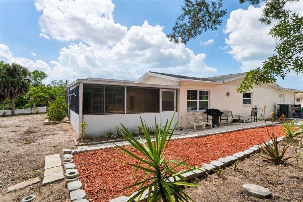 6955 Bottle Brush Drive Port Richey, FL 34668 - Photo 48 of 61 a view of a house with backyard