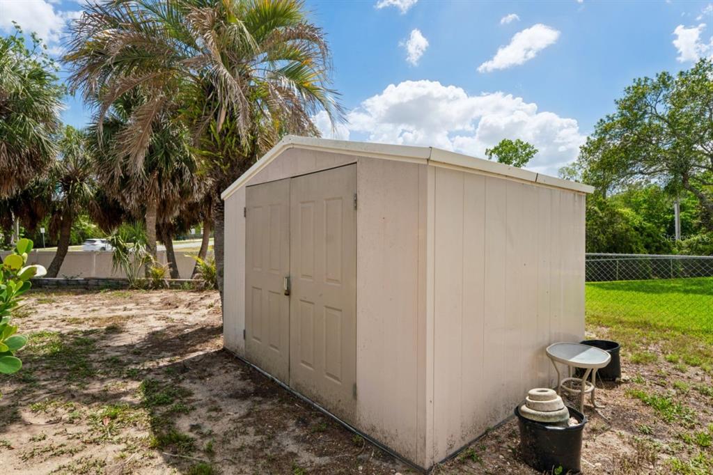 6955 Bottle Brush Drive Port Richey, FL 34668 - Photo 50 of 61 a backyard of a house with lots of green space