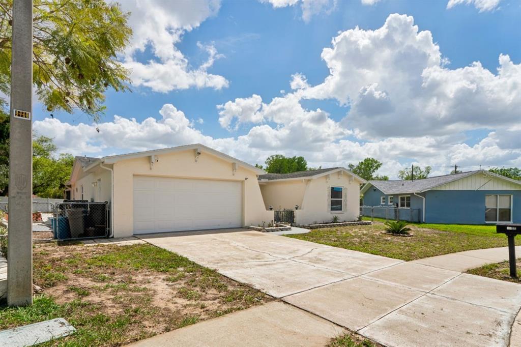 6955 Bottle Brush Drive Port Richey, FL 34668 - Photo 51 of 61 a view of a house with a yard
