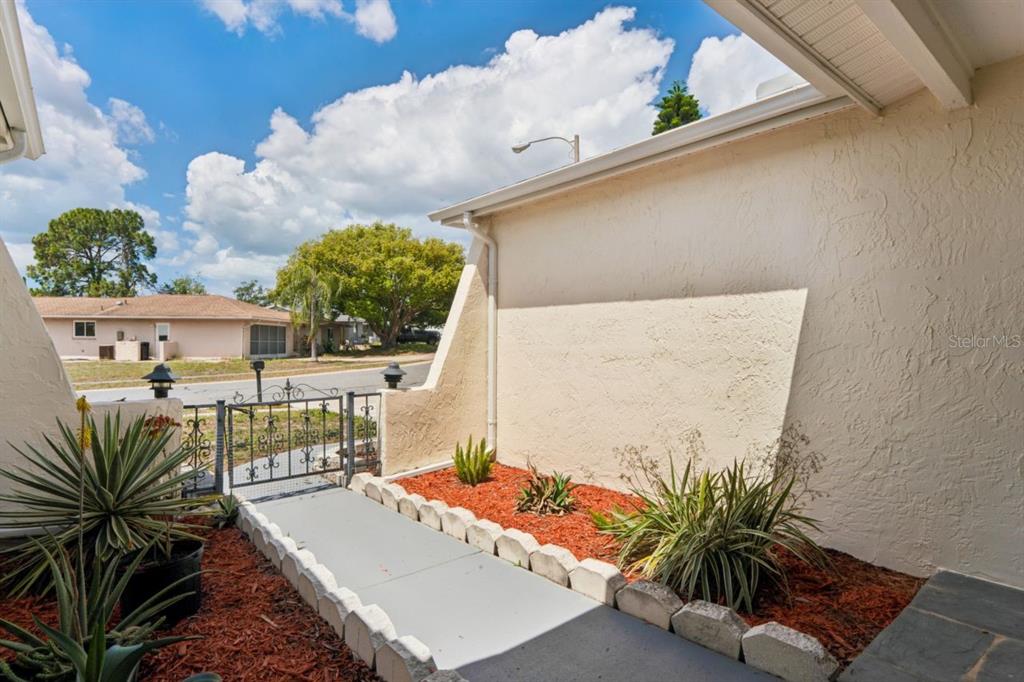 6955 Bottle Brush Drive Port Richey, FL 34668 - Photo 56 of 61 a picture of a table and chairs in patio