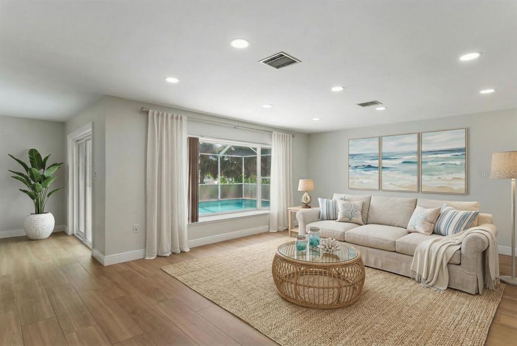 6955 Bottle Brush Drive Port Richey, FL 34668 - Photo 9 of 61 a living room with furniture and a large window