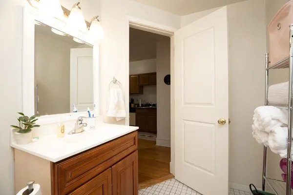 a bathroom with a sink a mirror and a shower