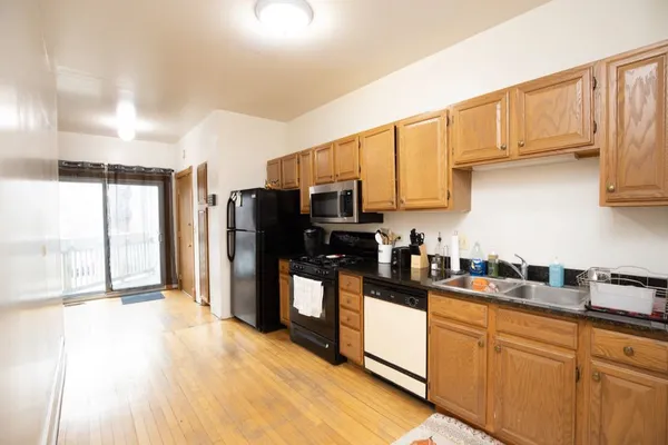 a kitchen with stainless steel appliances granite countertop a refrigerator sink and cabinets