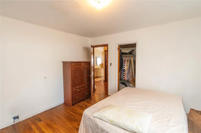 a bedroom with a bed and dresser