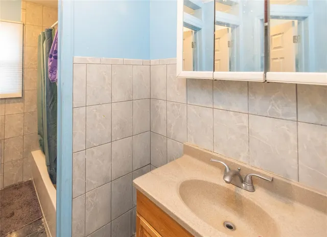 a bathroom with a sink and a window