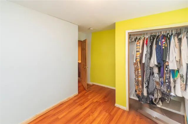a view of a room with wooden floor and closet