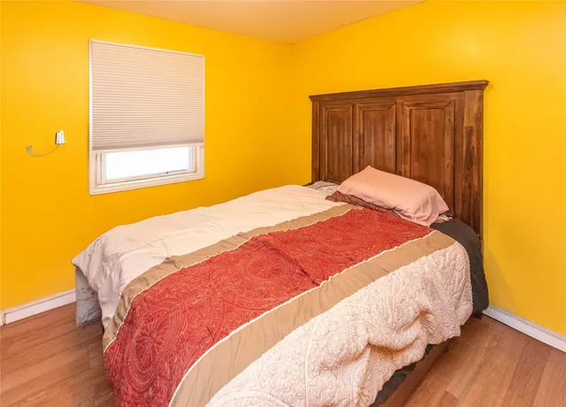 a bed sitting in a bedroom next to a wooden door