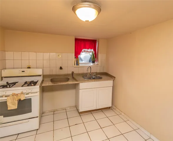 a kitchen with a stove a sink and a microwave