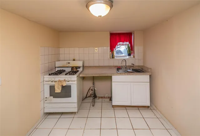 a kitchen with a sink cabinets and window