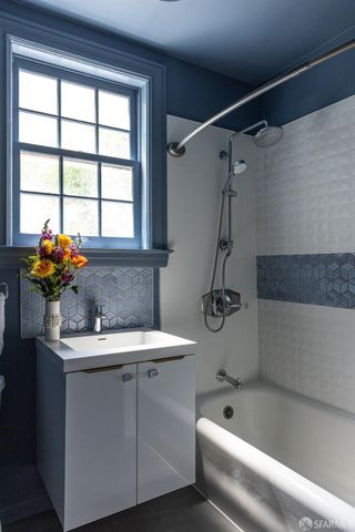 a view of a hallway view with wooden floor and a bathroom