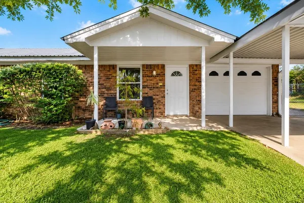 a view of a house with a yard and tree s