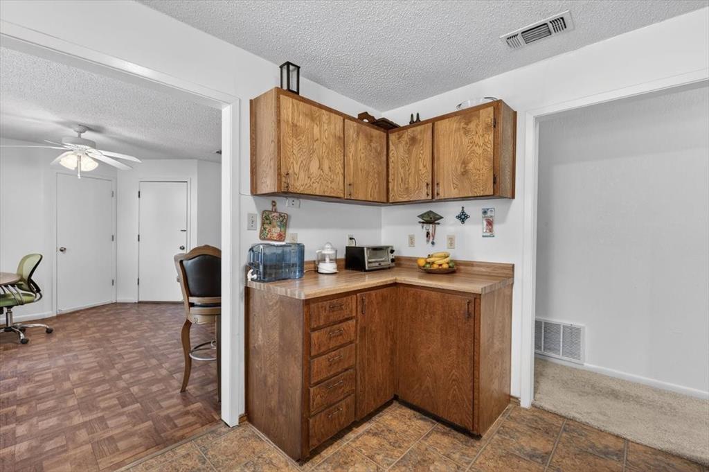1706 Hitching Post Road Granbury, TX 76049 - Photo 11 of 40 a kitchen with a sink cabinets and appliances