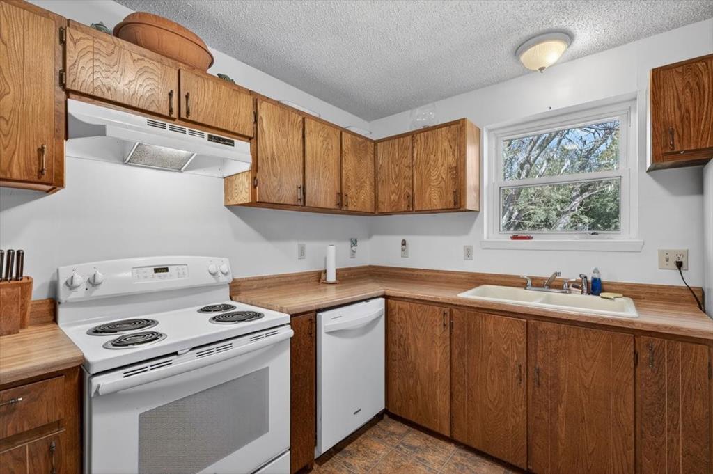1706 Hitching Post Road Granbury, TX 76049 - Photo 12 of 40 a view of a kitchen with sink and washing machine